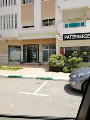 a car parked in a parking lot in front of a building at Appartement de luxe à 3 min de l aéroport in Nouaseur