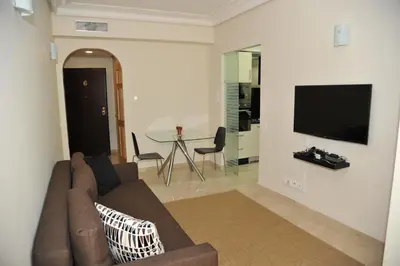 a living room with a couch and a table at Appartement à gauthier in Casablanca