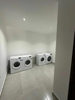 two washing and drying machines in a room at Luxury 1-Bedroom Apartment in Casablanca