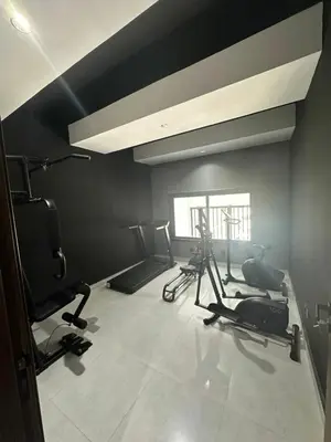 a gym with treadmills and exercise bikes in a room at Luxury 1-Bedroom Apartment in Casablanca