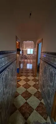 a room with a checkered floor in a house at Blue Wave Apartment in Temara