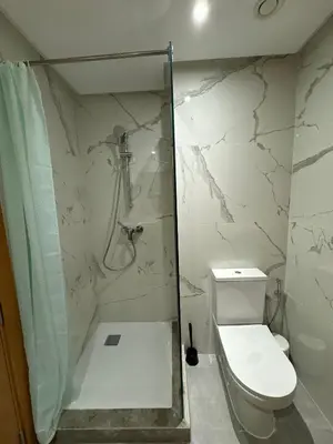 a bathroom with a shower and a toilet at Minimalist Escape - Between Rabat Agdal Station & Corniche in Rabat