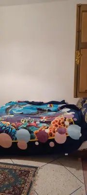a bed sitting on the floor in a room at CasAmer in Temara