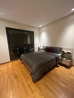 a bedroom with a large bed and a wooden floor at Stylish Luxe Apartment Casablanca Finance City! in Casablanca
