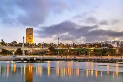 a view of a city with a clock tower and a river at Moderne berlin av terrasse in Rabat