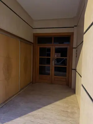 an empty room with a wooden door in a building at Moderne berlin av terrasse in Rabat