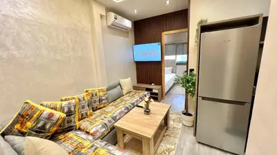 a living room with a couch and a table at Functional and Stylish Apartment in Agdal for Rabat Stay in Rabat