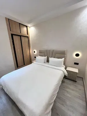 a bedroom with a large white bed in a room at Functional and Stylish Apartment in Agdal for Rabat Stay in Rabat