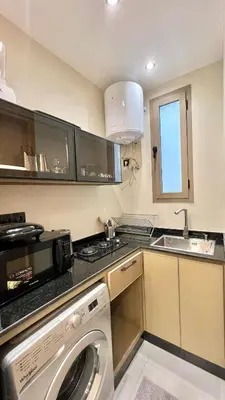 a kitchen with a washing machine and a sink at Functional and Stylish Apartment in Agdal for Rabat Stay in Rabat