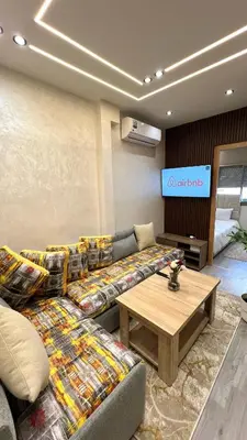 a living room with couches and a table at Functional and Stylish Apartment in Agdal for Rabat Stay in Rabat