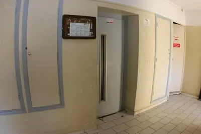 a hallway of a bathroom with a clock on the wall at Apartment Nahda Rabat in Rabat