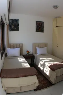a bedroom with two beds and a table at Apartment Nahda Rabat in Rabat