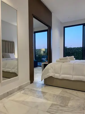 a bedroom with a bed and a large mirror at Quartier l oasis prêt de la gare in Casablanca