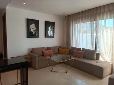 a living room with a couch and a table at Signature Leving 119 in Casablanca