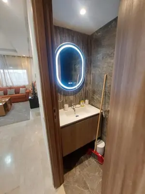 a bathroom with a sink and a round window at Séjour serein près aéroport in Nouaceur