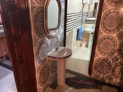 a bathroom with a sink and a mirror at Old school in Rabat