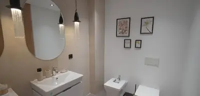 a white bathroom with two sinks and a mirror at AnfaPlace Residence, Casablanca, la Cornishe-Ain Diab in Casablanca