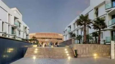 a group of buildings with stairs and palm trees at AnfaPlace Residence, Casablanca, la Cornishe-Ain Diab in Casablanca