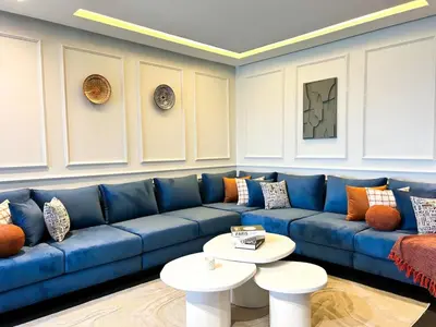 a living room with a blue couch and a table at Luxury apartment Marina in Casablanca