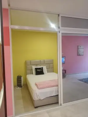 a bedroom with a bed and a yellow and pink wall at Bea & dozo in Casablanca