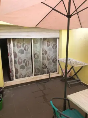 a screened in porch with a table and an umbrella at Bea & dozo in Casablanca