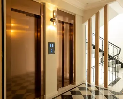 a hallway with a glass door and a staircase at Cozy & Modern Apartment with Rooftop Gym Great Casablanca Location in Casablanca