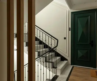 a hallway with a green door and stairs at Cozy & Modern Apartment with Rooftop Gym Great Casablanca Location in Casablanca