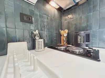 a kitchen with a stove and a microwave at Chic & Design Loft À 5 Minutes de la Corniche in Casablanca