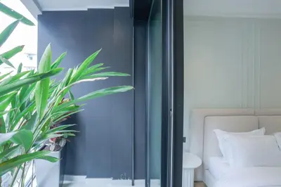 a bedroom with a bed and a potted plant at Cosy cocon Racine in Casablanca