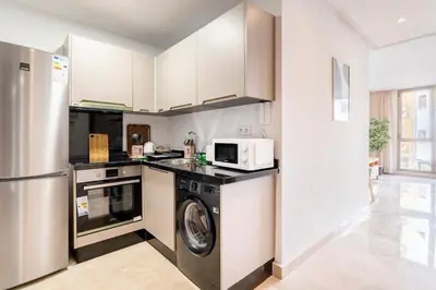 a kitchen with a washing machine and a microwave at Superb apartment Casa Bourgogne - parking in Casablanca