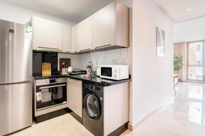a kitchen with a washing machine and a microwave at Superb apartment Casa Bourgogne - parking in Casablanca