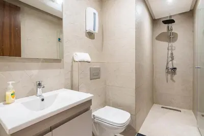 a white bathroom with a sink and a toilet at Superb apartment Casa Bourgogne - parking in Casablanca