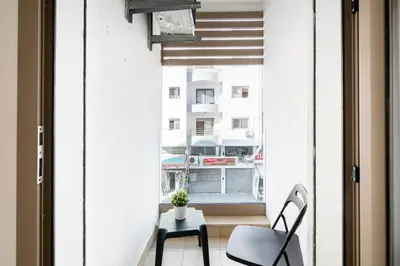 a small balcony with a chair and a table at Superb apartment Casa Bourgogne - parking in Casablanca