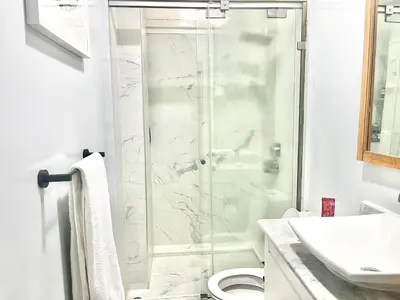 a bathroom with a shower and a toilet and a sink at Charming 3 Bedroom Apt in Agdal in Rabat