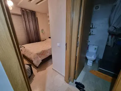 a small bathroom with a bed and a toilet at Heart of Casablanca - Tramway in Casablanca