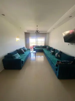 a living room with a green couch and a table at Ola Blanca 2 in Tamaris