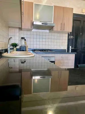 a kitchen with a sink and a counter top at Appartement moderne bord de mer in Sidi Rahal