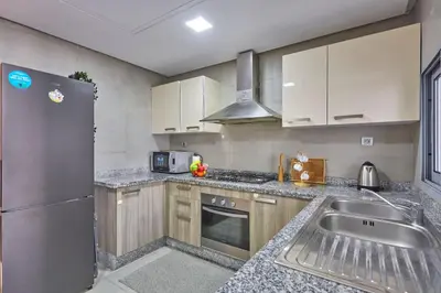 a kitchen with a stainless steel refrigerator and a sink at Luxury 3 Bedroom Getaway in Bouskouras Finest in Bouskoura