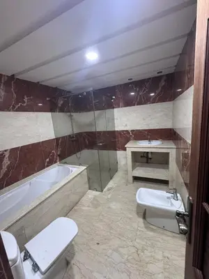 a bathroom with a tub and a toilet and a sink at Appartement à Rabat in Rabat