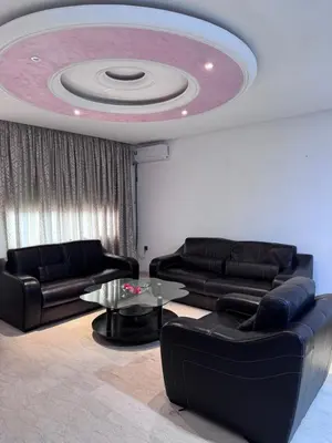 a living room with two couches and a circular ceiling at Appartement à Rabat in Rabat