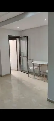 a room with a table and chairs in a building at Bel Appartement Confort et Commodités au Cœur de Casablanca Belvédère in Casablanca