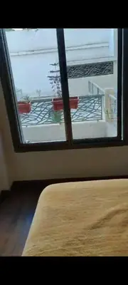 a room with a window with a view of a balcony at Bel Appartement Confort et Commodités au Cœur de Casablanca Belvédère in Casablanca