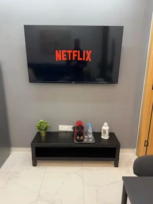 a tv with the netflix sign on a wall at Sublime Cozy Chic Studio Condo in Downtown Casablanca in Casablanca