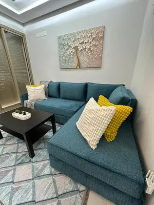 a living room with a blue couch and a table at Sublime Cozy Chic Studio Condo in Downtown Casablanca in Casablanca