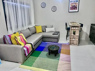 a living room with a couch and a table at Nice Studio Casablanca Mohammed V Airport in Derroua