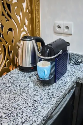 a kitchen counter with a toaster and a tea pot at Suite DeLuxe au coeur de la ville in Casablanca