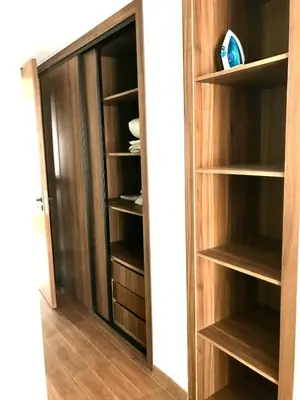 a closet with wooden shelves and a glass door at Beautiful Apartment Best View in Casablanca