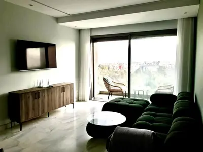 a living room with a couch and a large window at Beautiful Apartment Best View in Casablanca
