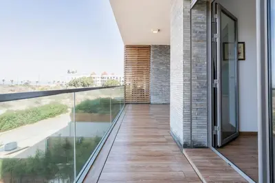 a glass balcony with a view of the ocean at Luxury Apartment, Seaview Close Beach in Casablanca