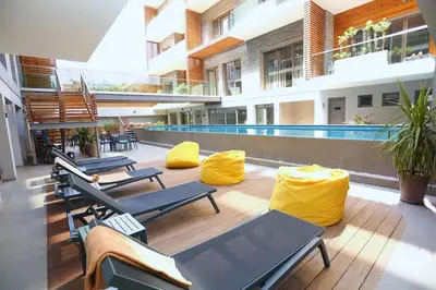 a patio with chairs and a pool in a building at Luxury Apartment, Seaview Close Beach in Casablanca